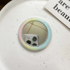 Detail view of MagSafe mirror phone grip with rainbow gradient edges on ceramic tray
