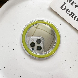 Detail of round MagSafe phone grip with lime green glitter border and makeup mirror
