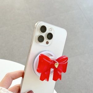 Supporto per telefono a fiocco rosso con dettaglio cuore dorato su smartphone