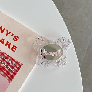 Detail of butterfly phone socket with built-in mirror and pink glitter sparkles