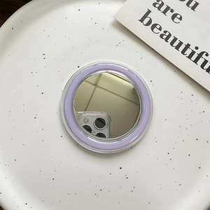 Detail view of a round MagSafe makeup mirror with a purple frame and high-reflective surface
