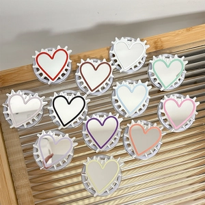 Heart-shaped expanding phone socket grips with colorful ridged frames and mirrors