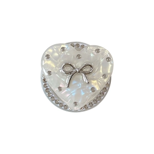 Sparkling rhinestone heart phone grip with silver bow accent and pearlescent finish