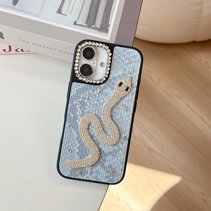 Detail of luxury light blue faux leather iPhone case featuring a rhinestone snake design