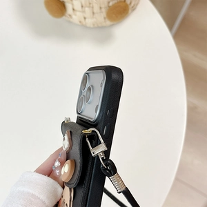 Close-up of black litchi leather phone case with cute bear pouch and detachable lanyard