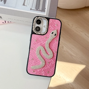 Close-up of pink snakeskin leather phone case with luxury rhinestone snake decoration