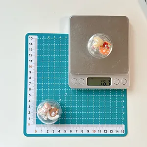 Close-up of cute cartoon phone grip weighing 16.7g on scale for size and weight reference