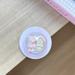 Detailed close-up of a purple circular phone grip with 3D miniature bear and house icons