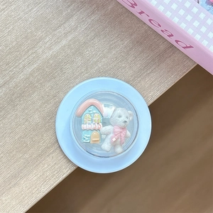 Macro view of blue miniature house and bear inside a 3D round telescopic phone socket