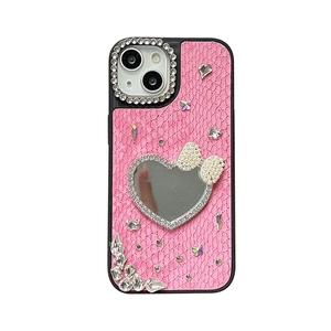 Pink snakeskin leather iPhone case featuring a heart mirror, bow, and rhinestone accents