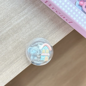 Detail of round acrylic phone socket with 3D koala and cartoon house miniature charms