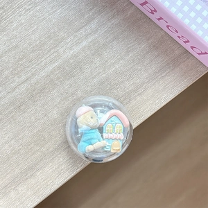 Close-up of cute 3D flocking bear and miniature house inside a round phone socket grip
