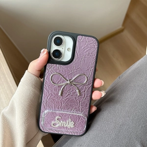 Detail of purple pleated texture phone case with silver bow and crystal Smile emblem
