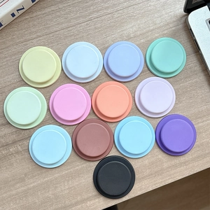Colorful magnetic phone socket stands in matte macaron shades on a wooden desk