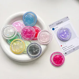 Colorful shell texture MagSafe phone grips in multiple iridescent colors displayed on a plate