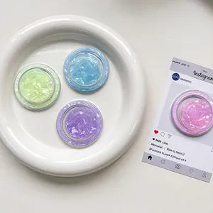 Magnetic MagSafe shell texture phone socket grip in assorted candy colors on white ceramic tray
