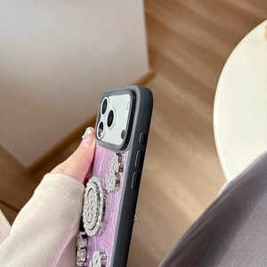 Detail of luxury purple crocodile leather iPhone case with rhinestone dollar sign decor