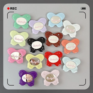 Glittery butterfly phone grips with mirror inlay in assorted rainbow colors and foldable base