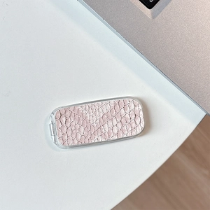 Detail of light pink crocodile pattern flip mirror with smooth acrylic edge finish