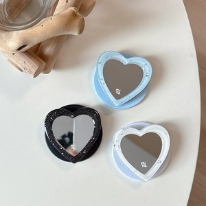 Glitter heart-shaped mirror phone stand in blue, black, and white colors with resin frame