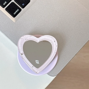 Detailed view of heart-shaped glitter mirror phone grip with purple telescopic stand