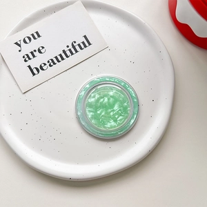 Detail of mint green marble pattern MagSafe phone socket with shell texture and resin finish