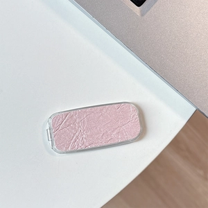 Detailed macro shot of pink shimmer eyeshadow with pearl finish in clear case