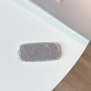 Detail of silver snake pattern flip mirror showing metallic texture and foldable hinge