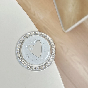 Macro view of a white heart phone grip with rhinestones and star sequins