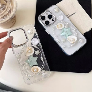Detailed view of 3D pearls, sea shells and star sequins on iPhone protective cases
