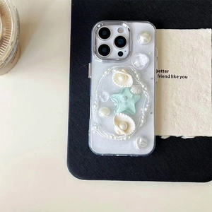 Detailed view of ocean-style clear phone case with 3D pearls shells and glitter stars