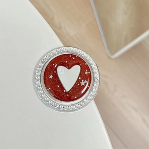 Detail of red glitter phone socket with heart motif, mi ne text and rhinestone border