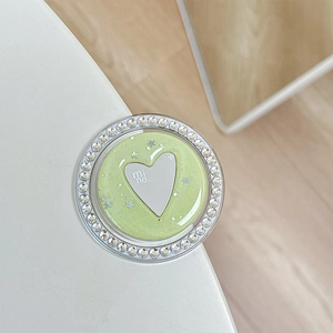 Detail view of heart-shaped glitter phone grip with rhinestones and star sequins