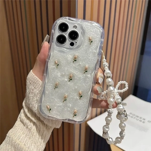 Detail of tulip patterned iPhone case with luxurious pearl bow lanyard and wavy edge design