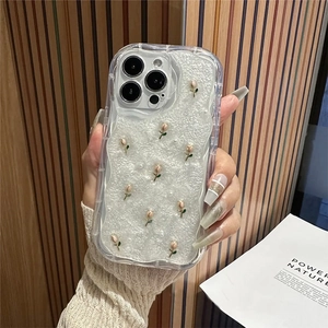 Macro shot of 3D rose and pearl accents on a creamy pearlescent iPhone protective case