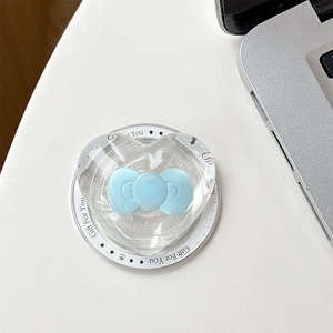 Detail of heart-shaped MagSafe phone grip with light blue bow and transparent resin shell