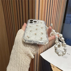 Detail showing tulip pearl phone case with floral embroidery and large white pearl lanyard