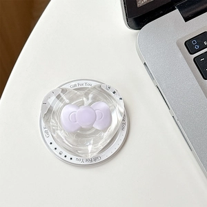 Macro detail of transparent heart phone grip with purple bow on a white gift card