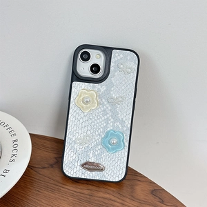 Detail of white snake skin texture phone case with resin flowers and pearl bow for iPhone