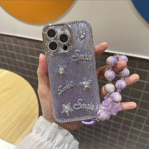 Detail of purple glitter iPhone case with Smile lettering, stars and beaded lanyard