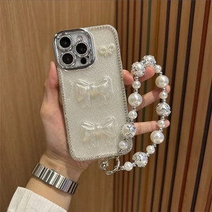 Coque iPhone luxe à paillettes avec nœuds 3D, strass et dragonne perle étoile élégante