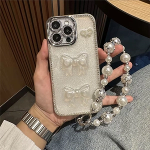 Détail de la coque de luxe pailletée avec nœuds 3D et dragonne en perles premium