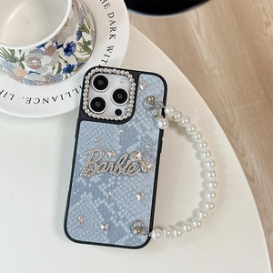 Detailed view of light blue snakeskin texture iPhone case with rhinestone Barbie logo