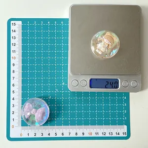Close-up of translucent bear and bow resin phone grips showing 3.5cm diameter on scale