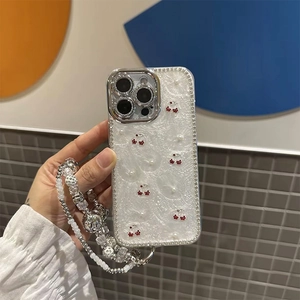 Detail of white pearl texture iPhone case with 3D cherry accents and beaded strap
