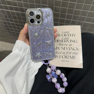 Detail of glitter purple iPhone case with star charms, Smile logo, and beaded strap