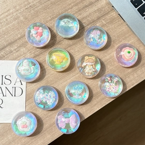Iridescent bear and honey-themed clear pop-sockets on a wooden desk for smartphones