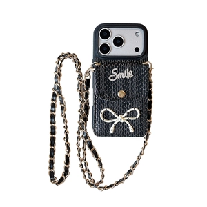 Black snakeskin texture iPhone case with crossbody chain strap and polka dot bow detail