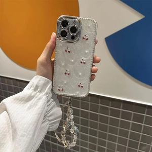 Detailed view of pearl phone case with cherry accents and crystal bead wrist strap