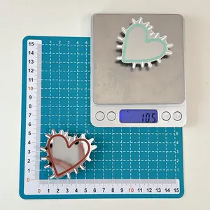 Detail showing heart mirror phone grips size and 10.5g weight on a scale